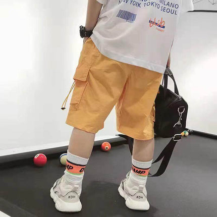 Summer Boys' Shorts - Cropped Cargo, Size 100-140 cm in yellow cargo shown on child with cargo pockets, mid-waist cropped leg for active play