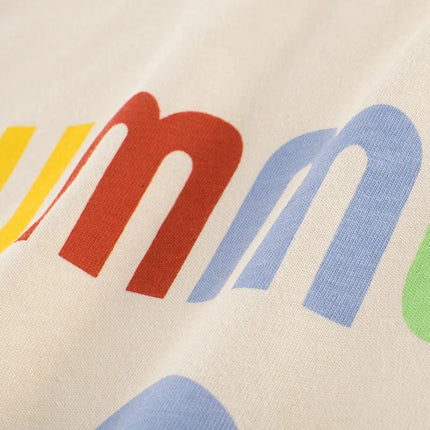 Summer Girls Short-Sleeved Rice Apricot T-Shirt Cotton with colorful cartoon letters close-up on soft 100% cotton fabric