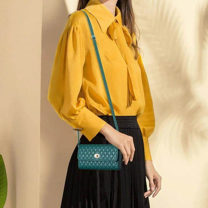 Crossbody PU Horizontal Bag for Large Capacity Everyday Essentials in teal PU leather worn crossbody with quilted texture and gold-tone clasp