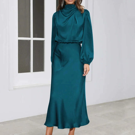 Satin Halterneck Mid Length Dress With Long Sleeves For Evening in teal satin with high halter neck, lantern sleeves and stitched patchwork skirt