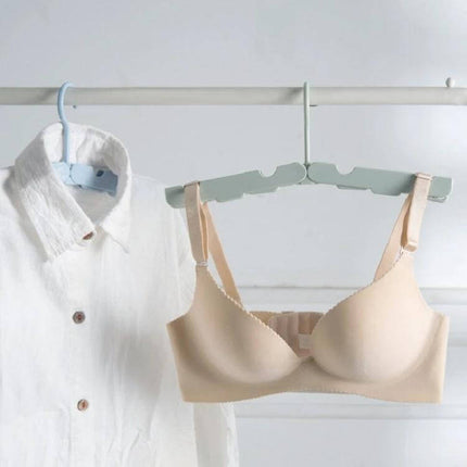 Travel Foldable Clothes Hanger On The Go Anti Skid displaying lightweight ABS foldable hanger holding shirt and bra for travel drying