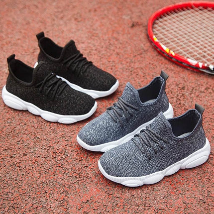 Unisex Kids Sneakers With Wear Resistant Sole And EVA Upper on playground surface showing knit EVA upper and white wear-resistant plastic sole