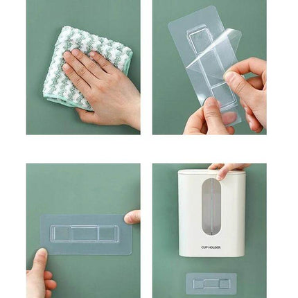 Wall Mounted Paper Cup Dispenser, Double Tube For Easy Cup Access - white double-tube cup holder being mounted with adhesive strip beside water dispenser