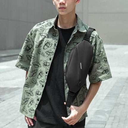 Weixier Waterproof Waist Bag Black For Everyday Use shown worn crossbody on a man, compact waterproof oxford cloth bag holding phone and essentials