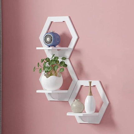 Wall Hanging Shelf For Flower Pot And Storage Square white hexagon wall-mounted shelves holding small plant and vases on pink wall