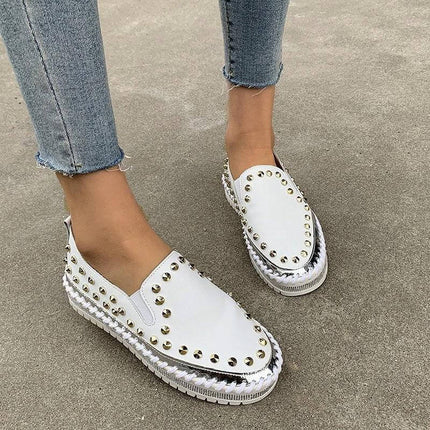 Rivet Canvas Flat Sneakers For Women Casual Everyday white rivet-studded canvas slip-on sneakers on model, low flat heel for city commuting