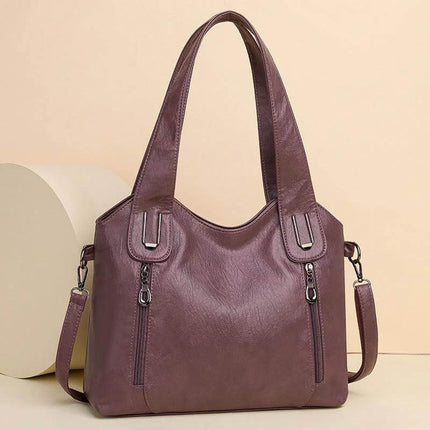 Women's Large Capacity PU Handbag For Everyday Use - plum PU leather shoulder bag with visible stitching, zip pockets, roomy structured-but-soft carry
