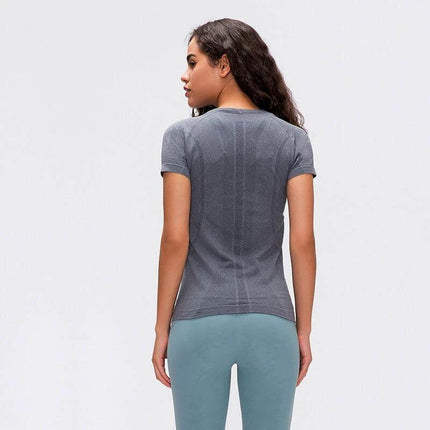Womens Quick Dry Running Top Short Sleeve For Yoga modeled from back in grey, breathable moisture-wicking fabric and stretch-fit for studio and outdoor workouts