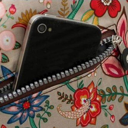 Women's Waterproof Nylon Shoulder Bag For Everyday Use with floral print, zipper pocket holding a smartphone, nylon exterior and polyester lining