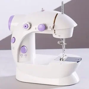 Compact white sewing machine with purple knobs and a silver needle plate.
