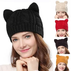 Woman wearing a black knit beanie hat with cat ears, smiling at the camera.
