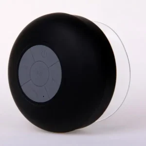 Black portable Bluetooth speaker with control buttons on the front and a transparent base.