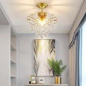 Gold chandelier with crystal accents hanging from a ceiling in a room.