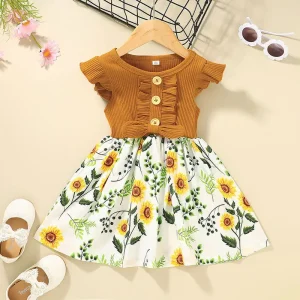 A yellow and white dress for girls featuring a floral pattern and button details on the bodice.