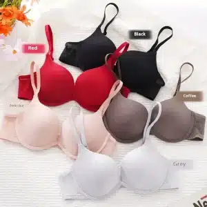 Collection of bras in various colors including red, black, coffee, pink skin, and grey arranged on a textured surface.