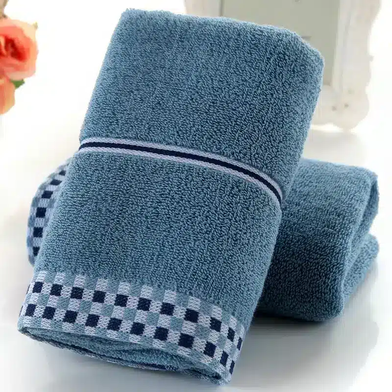 Luxuriously Soft Absorbent Facial Towels for Couples, 2-Pack 8 Two Folded Blue Hand Towels Featuring A Checkered Trim Along The Bottom Edge.