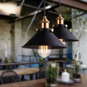 Two black pendant light fixtures with gold accents hanging from a ceiling.