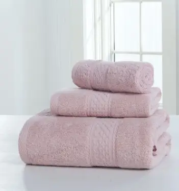 Luxurious Thick Cotton Bath Towel & Robe Set for Spa-Like Comfort 2 Three Stacked Pink Towels Of Varying Sizes Displayed On A Flat Surface.