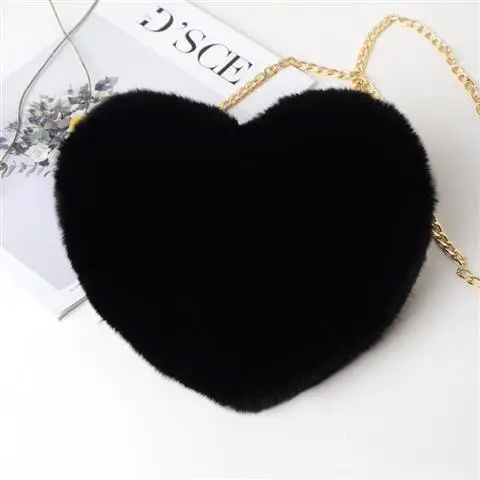 Chic Plush Chain Shoulder Bag for Valentine's Day Delight 8 Black Heart-Shaped Handbag Made Of Fur With A Gold Chain Strap.