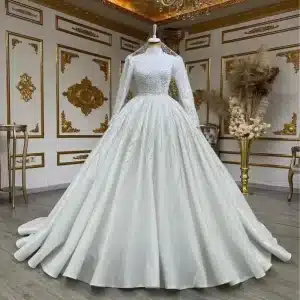 Elegant white wedding dress featuring long sleeves and a full skirt displayed on a mannequin.