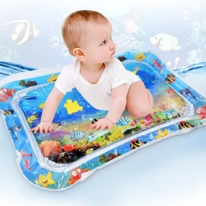 A baby playing on a water play mat featuring colorful underwater scenes with fish and sea creatures.