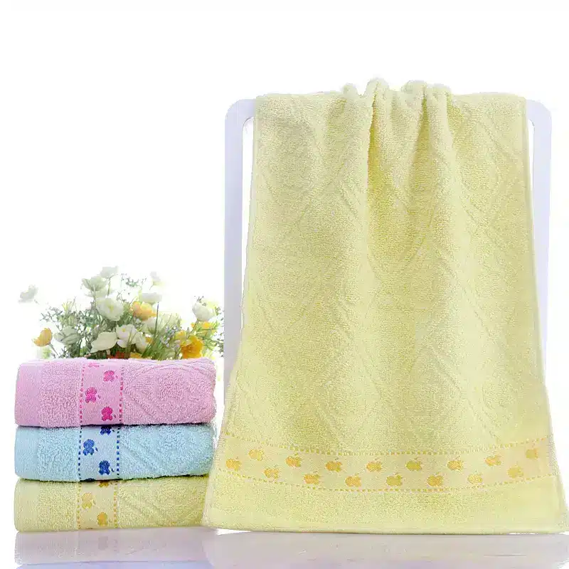 Ultra-Soft Cotton Face Towel for Daily Comfort and Care 2 A Stack Of Colored Towels Including Yellow, Pink, And Blue, With A Yellow Towel Displayed Prominently In The Center.