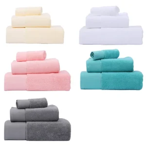 Five stacks of towels in yellow, white, pink, teal, and gray arranged neatly.