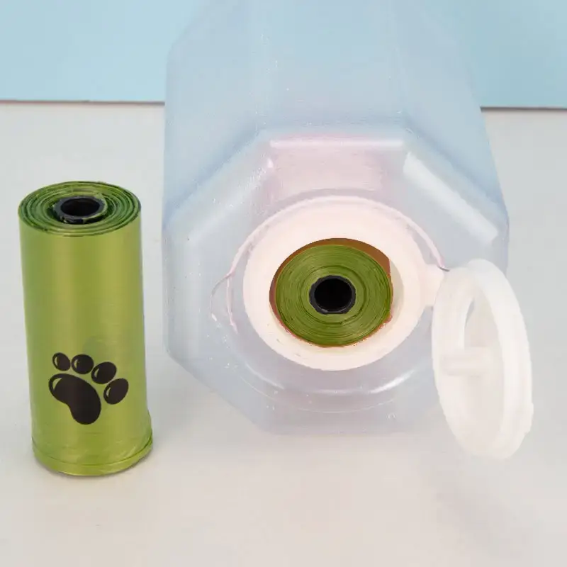 3-in-1 Leak-Proof Travel Bottle & Feeder for Pets 10 Green Pet Waste Bag Roll Next To A Transparent Dispenser With A Cap And A Paw Print Design.