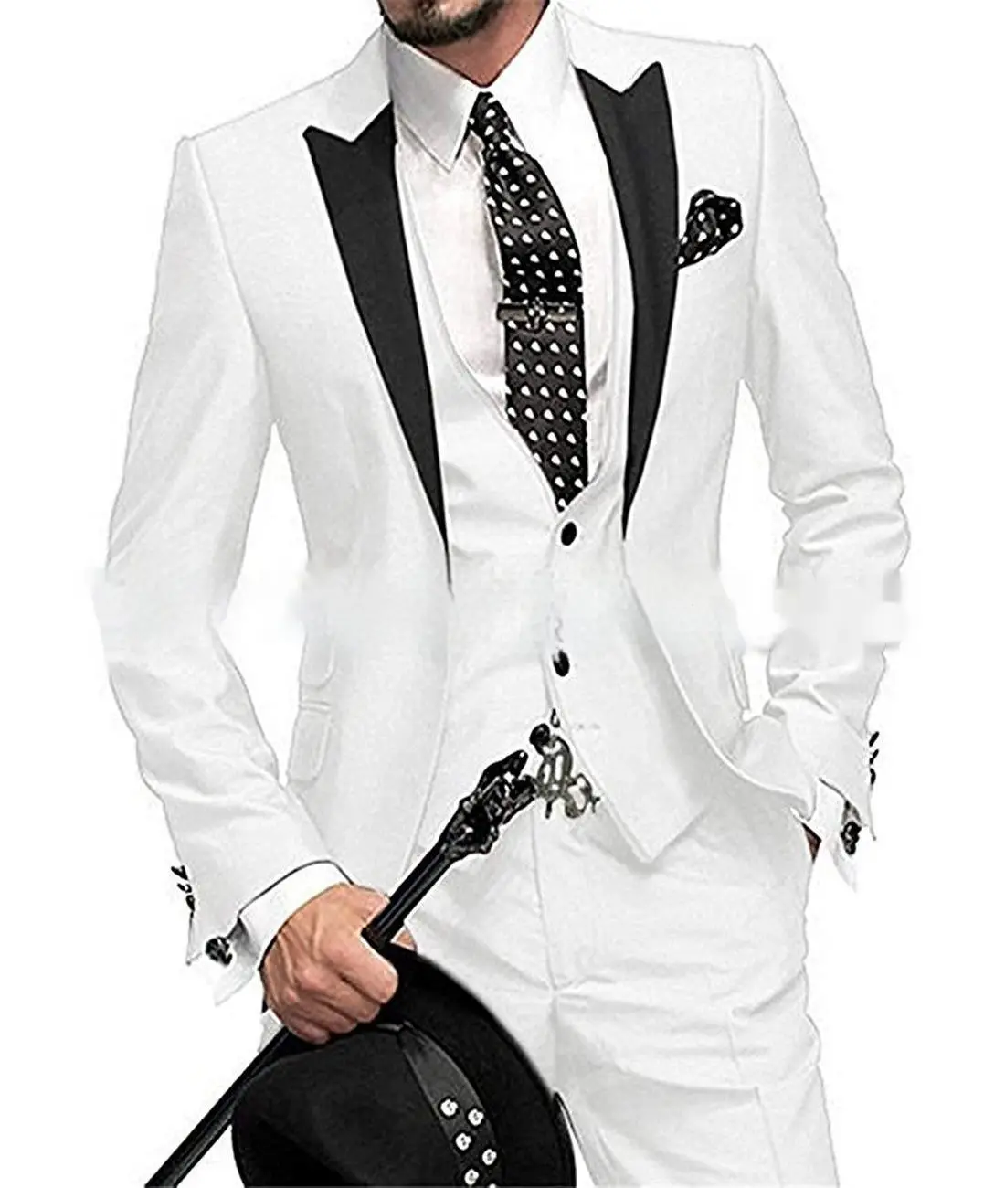 Chic Black Collar Blocked Three Piece Set for Modern Style 6 A Man Wearing A White Tuxedo Suit With Black Lapels And A Polka Dot Tie, Holding A Black Hat.