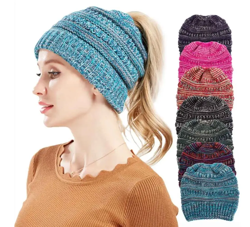 Chic Mixed Color Knitted Ponytail Hat for Ladies 1 A Woman Wearing A Blue Knitted Beanie Hat With A Ponytail, Surrounded By Other Colored Beanie Hats.