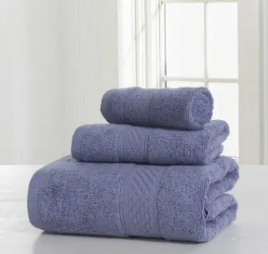 Luxurious Thick Cotton Bath Towel & Robe Set for Spa-Like Comfort 4 Three Stacked Purple Bath Towels Of Varying Sizes On A Flat Surface.