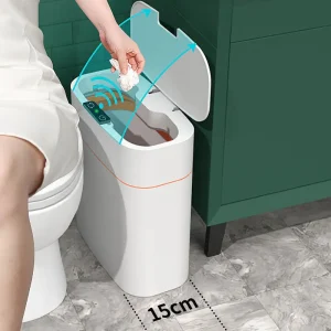 A person using an automatic sensor trash bin with a lid that opens when approached.