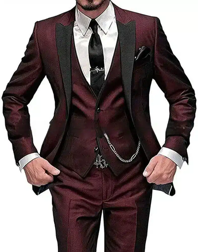 Chic Black Collar Blocked Three Piece Set for Modern Style 5 A Man Wearing A Burgundy Suit With A Waistcoat And A Black Tie, Hands In Pockets.