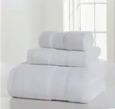 Luxurious Thick Cotton Bath Towel & Robe Set for Spa-Like Comfort 5 Three Stacked White Bath Towels With Textured Patterns On A Light Surface.