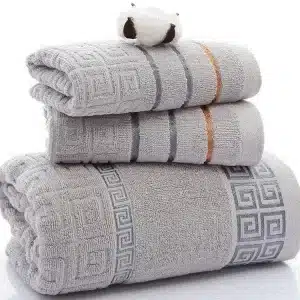 Three stacked gray towels featuring decorative borders in blue and orange.