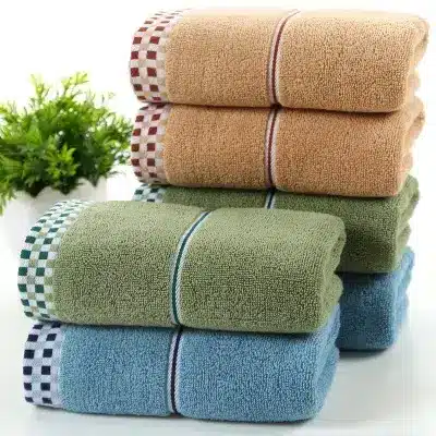 Luxuriously Soft Absorbent Facial Towels for Couples, 2-Pack 1 Stack Of Towels In Various Colors Including Orange, Green, And Blue With Checkered Bands.