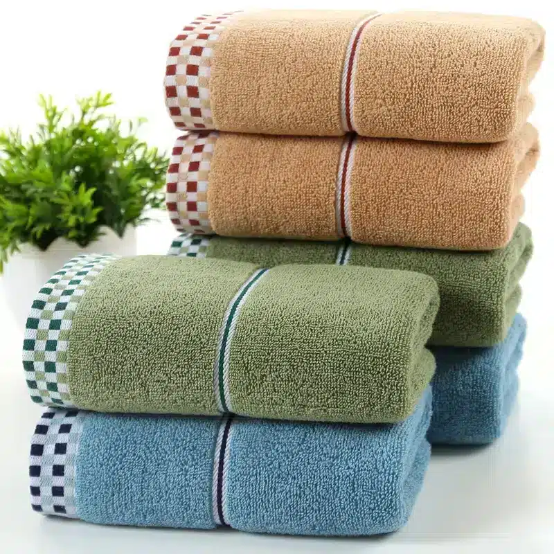 Luxuriously Soft Absorbent Facial Towels for Couples, 2-Pack 6 Stacked Towels In Orange, Green, And Blue With Checkered Trim On Each.