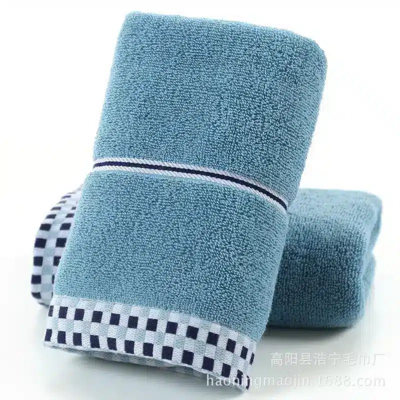 Luxuriously Soft Absorbent Facial Towels for Couples, 2-Pack 3 Two Blue Cotton Bath Towels Stacked With A Checkered Trim At The Bottom.