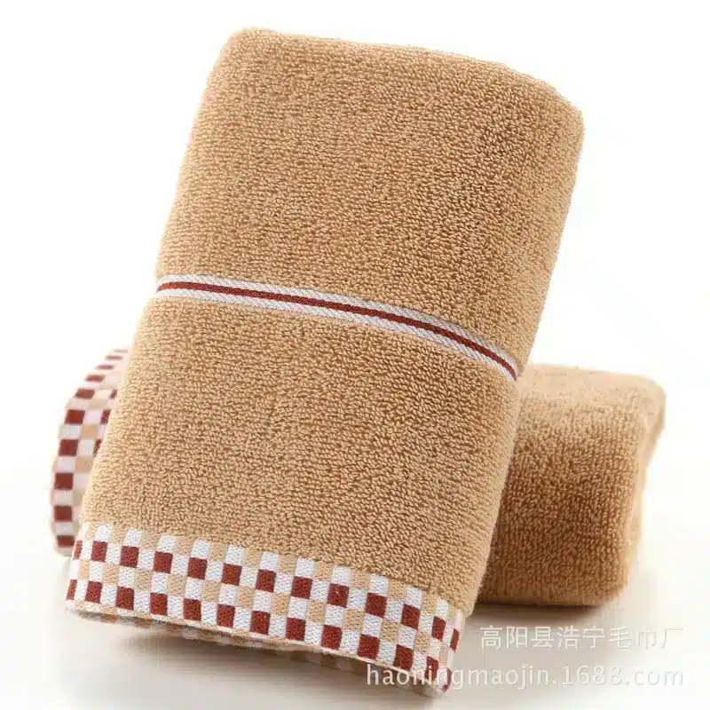 Luxuriously Soft Absorbent Facial Towels for Couples, 2-Pack 5 Two Folded Brown Cotton Hand Towels With A Checkered Trim At The Bottom.