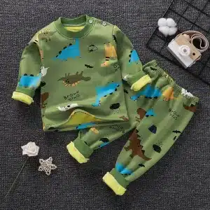 Children's two-piece pajama set featuring a dinosaur print in various colors on a green background.