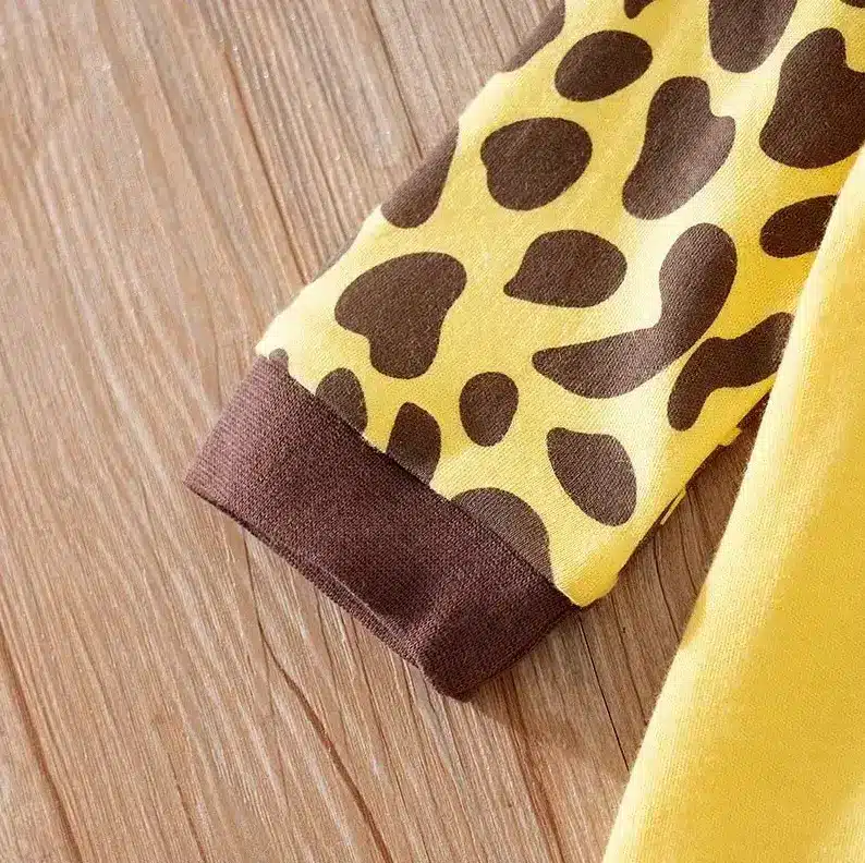 Adorable Baby Jumpsuit Rompers for Easy and Stylish Dressing 4 Close-Up Of A Yellow Fabric Sleeve With Brown Leopard Print Patterns And A Brown Cuff.