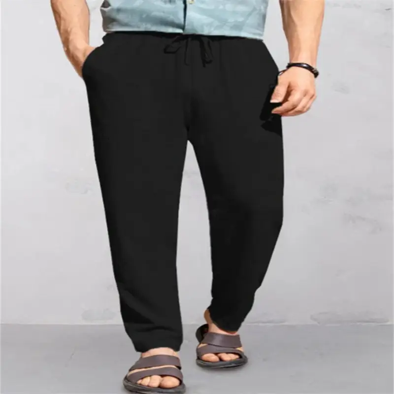 Men's Breathable Linen Outdoor Pants with Drawstring Comfort 8 Man Wearing Black Casual Pants With A Drawstring And Sandals, Standing Against A Neutral Background.