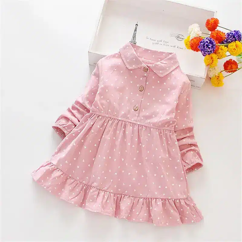 Charming Spring Princess Dress for Little Girls - Adorable Skirt! 5 A Pink Dress Featuring White Heart Patterns And A Ruffled Hem, With A Collar And Buttons.