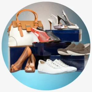 A Collection Of Different Types Of Shoes And A Handbag Arranged On Blue Boxes.
