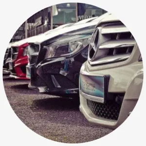 A Row Of Luxury Cars Including A Mercedes-Benz And Other Models Parked In A Line.