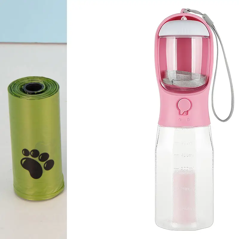 3-in-1 Leak-Proof Travel Bottle & Feeder for Pets 5 A Pink Pet Water Bottle With A Built-In Bowl And A Green Roll Of Pet Waste Bags Beside It.