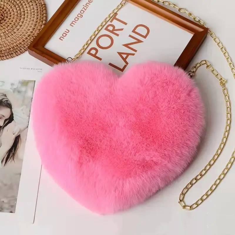 Chic Plush Chain Shoulder Bag for Valentine's Day Delight 3 Pink Heart-Shaped Bag Made Of Soft Fur With A Gold Chain Strap.