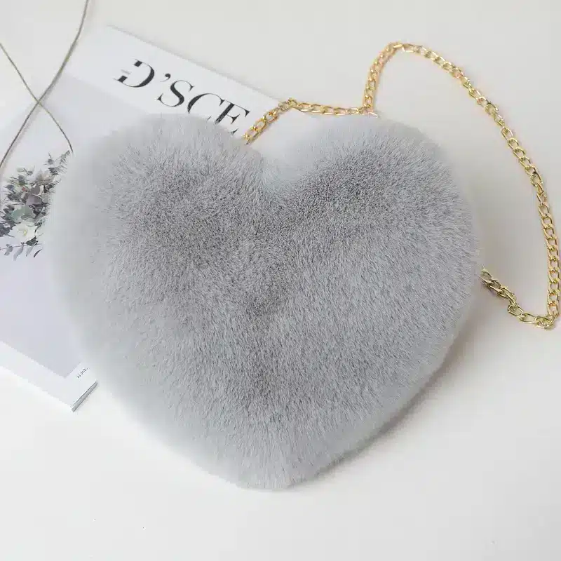 Chic Plush Chain Shoulder Bag for Valentine's Day Delight 10 Gray Heart-Shaped Bag Made Of Fur With A Gold Chain Strap.