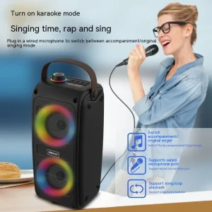 Portable karaoke speaker with colorful LED lights and a microphone, designed for singing and music playback.