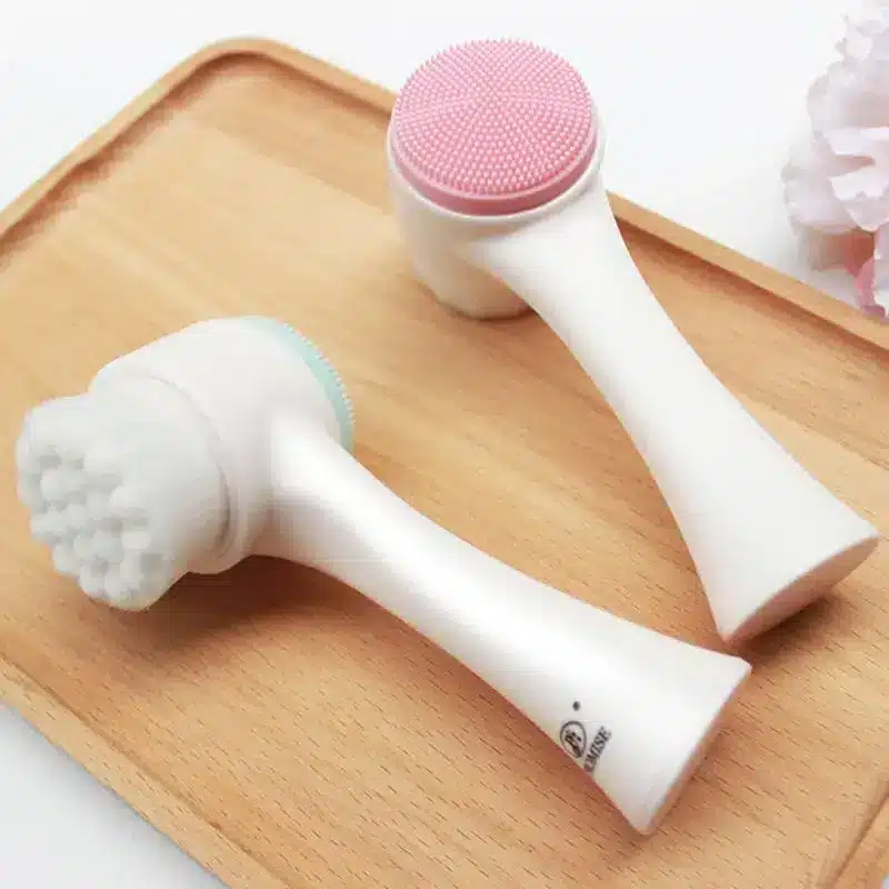 Revitalizing Cleansing Face Wash for Radiant Skin 3 Two Facial Cleansing Brushes With Silicone And Bristle Heads On A Wooden Tray.